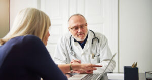 Patient and doctor discussing vein consultation steps at Miami Vein Institute in Coral Gables during a first vein consultation.